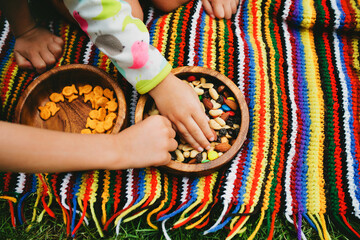 Hands of two little kids grabbing a snack