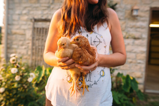 Woman holding her two chickens