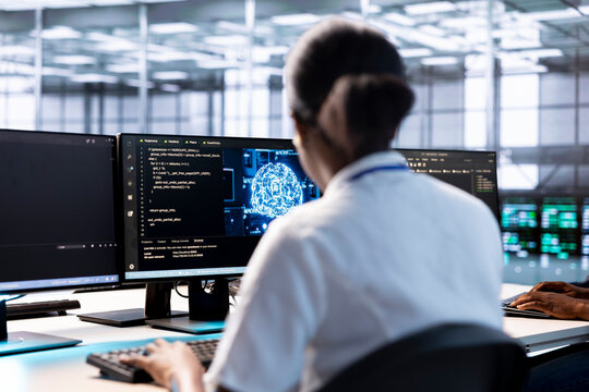 Server hub IT expert using AI systems to input data faster during complex computational tasks. African american woman in data center using artificial intelligence parallel processing tech