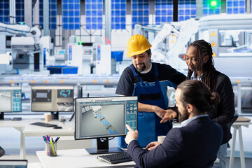 Solar panels plant engineering team analyzing performance data and optimizing efficiency. Teamworking photovoltaics factory coworkers working on innovative solar cells design prototype