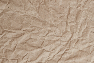 Wrinkled craft paper crumpled texture. Crumpled brown kraft paper texture with deep wrinkles and...