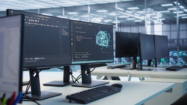 Close up of code on computer screens in server hub used for data processing requirements of artificial intelligence workloads and neural network machine learning tech, trucking right shot