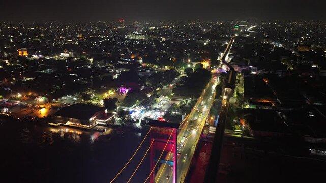 Aerial shot of Ampera Bridge at night, one of the landmarks of Palembang city, South Sumatra, Indonesia