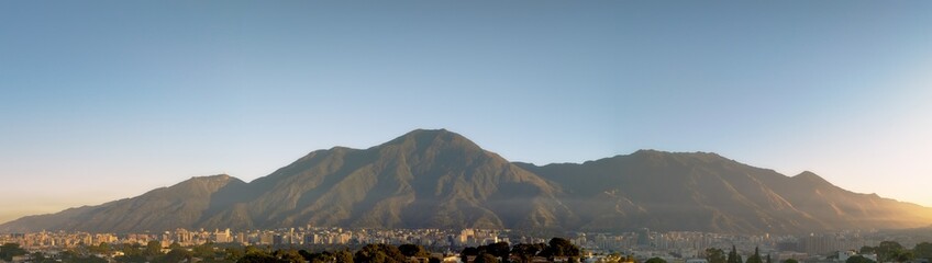 sunrise panoramic view of Caracas and the iconic mountain named Avila, Showing a wide view of...