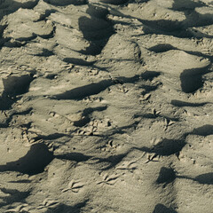 close-up of sand on the beach with impressions and random ripples and dunes nature landscape...