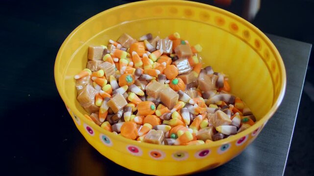 Hands Grabbing Halloween Candy and dropping it