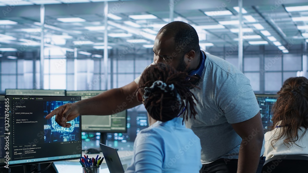 Poster manager coming to technician desk to give instructions on doing maintenance on artificial intelligen
