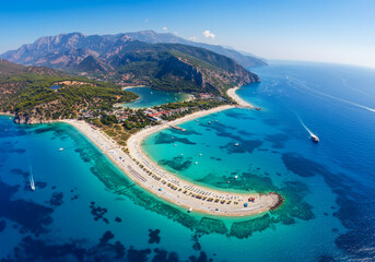Fototapeta premium Oludeniz Blue Lagoon with turquoise sea, paradise white sand beach and tourist boat