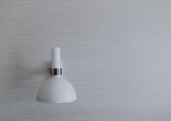 Minimalist White Wall Sconce on Textured Gray Wallpaper