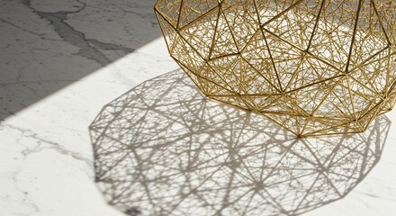 Geometric gold wireframe sculpture casting intricate shadows on a marble surface