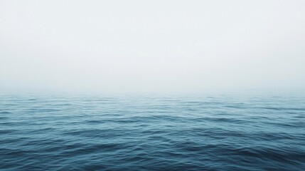 Obraz premium Calm Ocean Horizon Under Misty Sky