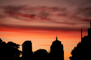 city skyline silhouette at dawn with clouds 