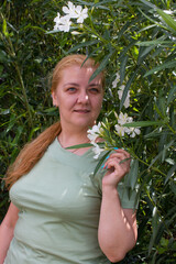 Fototapeta premium A beautiful woman on a walk in the park. The smiling blonde