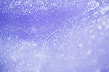 Close up texture of frozen lake cracked ice as background