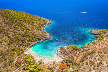 Obraz premium A breathtaking aerial view of Dubovica Beach on Hvar Island, Croatia, showcasing its crystal-clear turquoise waters, charming stone house by the shore, and unspoiled Adriatic coastline