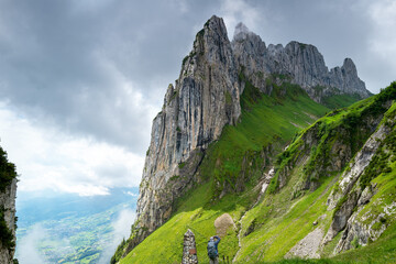 Hiker photographing Saxer Lücke, the Appenzell alps is a popular hiking destination in Switzerland