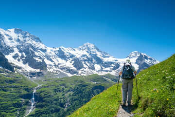 Senior man hiking the Jungfrau region of the Swiss alps in Switzerland.