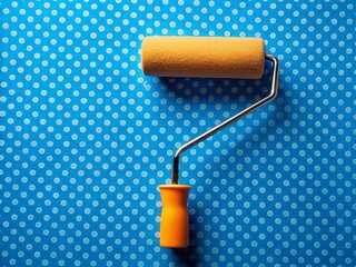 Obraz premium Macro Close-up of Paint Roller on Blue Polka Dot Wallpaper