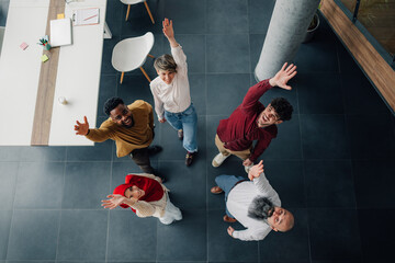 Happy business team waving at camera in modern office
