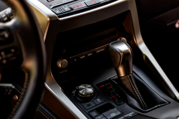 Inside the car.Gear shift handle in a modern car.Vehicle interior.Dashboard, inner workings of a...