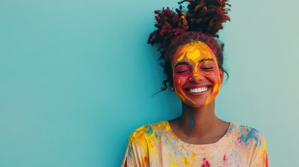 Joyful woman smiling with colorful powder paint on her face