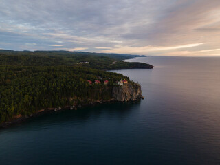 stunning aerial view of Split Rock Lighthouse at sunrise, glowing over Lake Superior&rsquo;s summer shoreline. Minnesota 