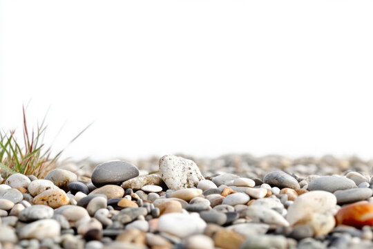 Close-up view of a variety of smooth pebbles on a tranquil beach with bright white sky in the background. - Powered by Adobe