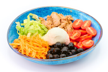 Salad with Buffalo mozzarella, tuna fish, cherry tomatoes, iceberg salad, olives, carrots,  in the blue plate with white background