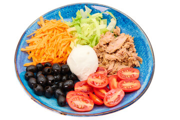 Salad with Buffalo mozzarella, tuna fish, cherry tomatoes, iceberg salad, olives, carrots,  in the blue plate with white background