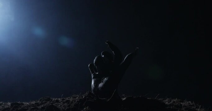 Zombie hand rising out from the ground
