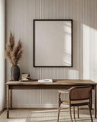 Minimalist home office with wooden desk, chair, pampas grass, and blank frame on textured wall.