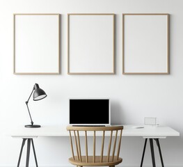 Minimalist home office workspace with three blank frames, computer, and chair.