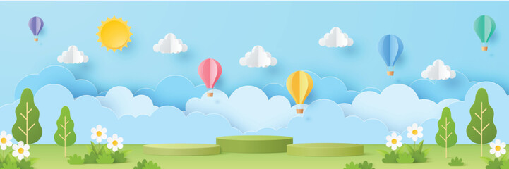 Podium in 3d paper cut style on spring summer season scene with sun, clouds, balloons on blue sky banner background. Green nature landscape backdrop for product display advertising, presentation. © i_fleurs
