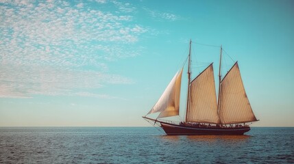 A classic wooden sailing ship with large white sails glides across the sea under a soft blue sky