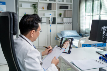 Asian doctor providing telehealth video consultation to online patient.	
