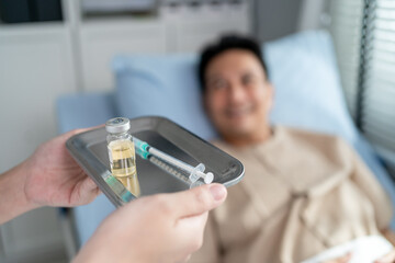 Close up of medical nurse making vaccine injection to mature male patient. 