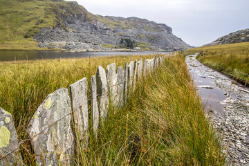 Near Blaenau Ffestiniog, Gwynedd. Llyn Cwmorthin with the ruin of Cwmorthin Terrace, the Compressor House and the quarry in the background