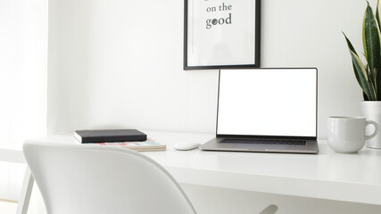 Minimalist workspace with clean desk, modern laptop, plant decor, ideal for productivity and professional lifestyle.