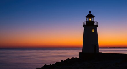 Lighthouse illuminated at sunset