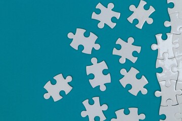 White puzzles scattered on blue background
