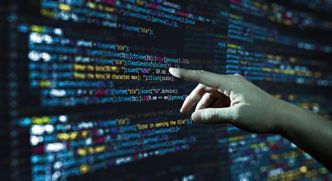 Human hand pointing at the abstract Modern tech of Programming code screen developer. C Programming Language of Computer script and Technology background of software.
