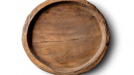 An empty, rustic wooden platter with detailed carving around its edge, sitting solitary against a white backdrop, invites culinary creations.