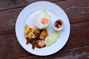 Stir fried squid and shrimp with basil, Rice topped with fried egg