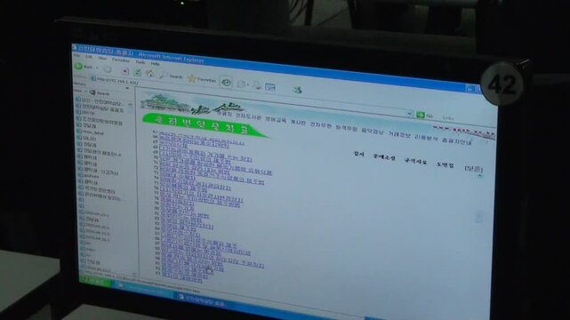 North Korean men working on computers, Pyongyang, North Korea