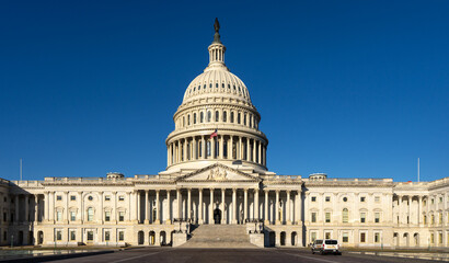 Obraz premium Capitol as a symbol of democracy in Washington, DC. The Capitol building on Capitol Hill. US government. American flag adorns the dome of the historic Capitol. The Senate. Capital of America.
