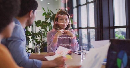 DNA strand animation over diverse team discussing documents at office table - Powered by Adobe