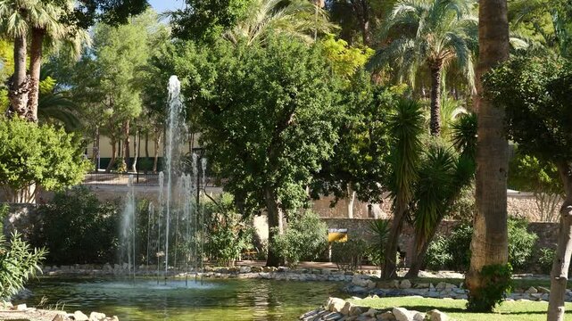 Slow motion of a fountain in a nice mediterranean park. "Padre Palau" park, Crevillente, Spain. x0.5 slow motion