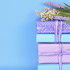 A stack of beautifully wrapped Easter gifts with pastel ribbons