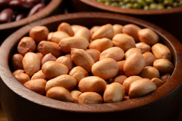 Raw Peanut in wooden bowl. Close-up