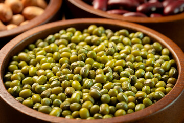 Raw mung bean in wooden bowl. Close-up